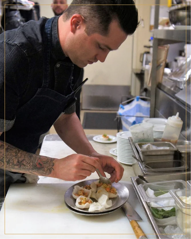 Chef Justin skillfully crafting the dish with precision and care