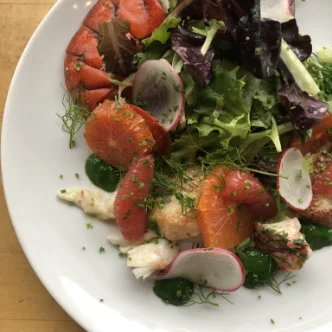 A plate of salad with lobster